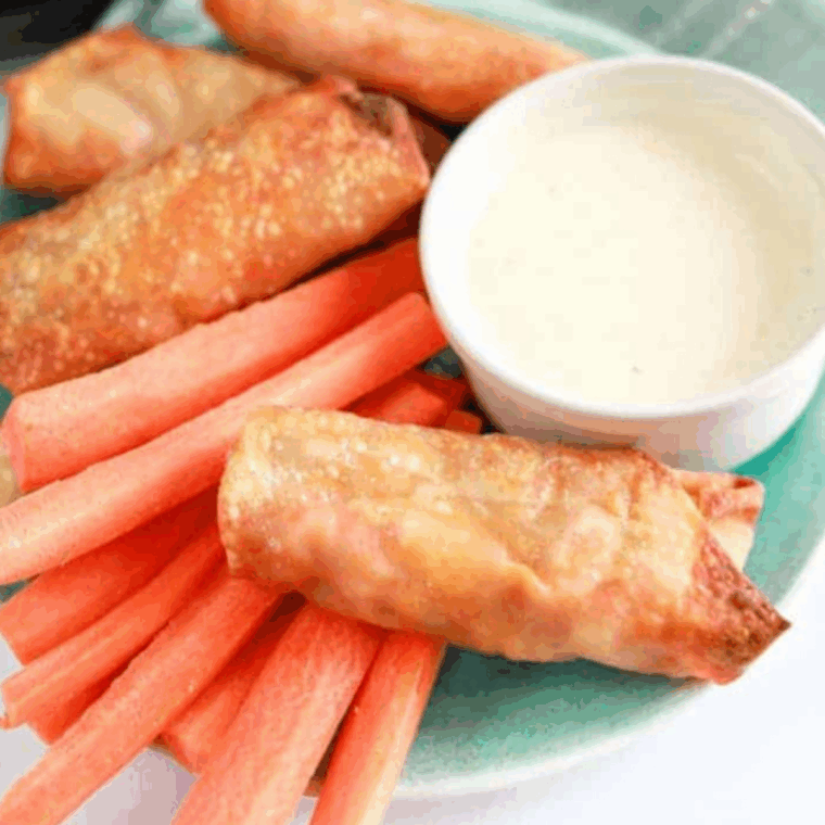 Golden air fryer buffalo chicken egg rolls with melted cheese and spicy chicken filling