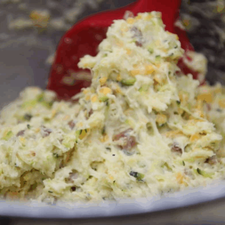  Zucchini Muffins batter in a large gray mixing bowl.