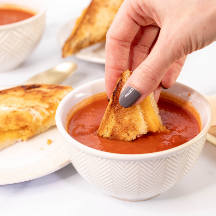Crispy Ninja Crispi grilled cheese sandwich served with tomato soup for an easy lunch idea