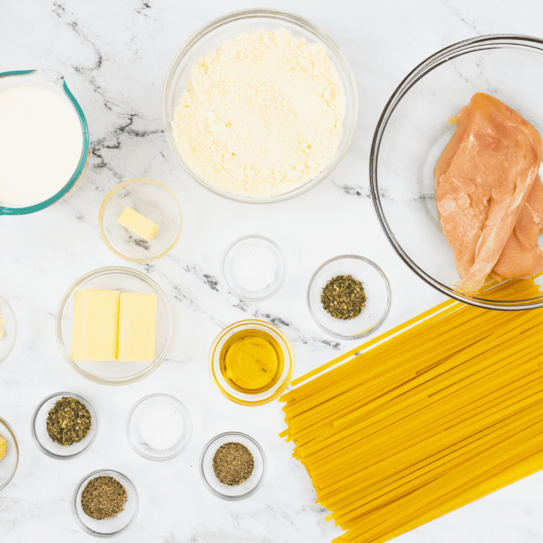 Ingredients needed for Ninja Foodi Chicken Alfredo (One-Pot, 22 Minutes, No Curdling) on kitchen table.