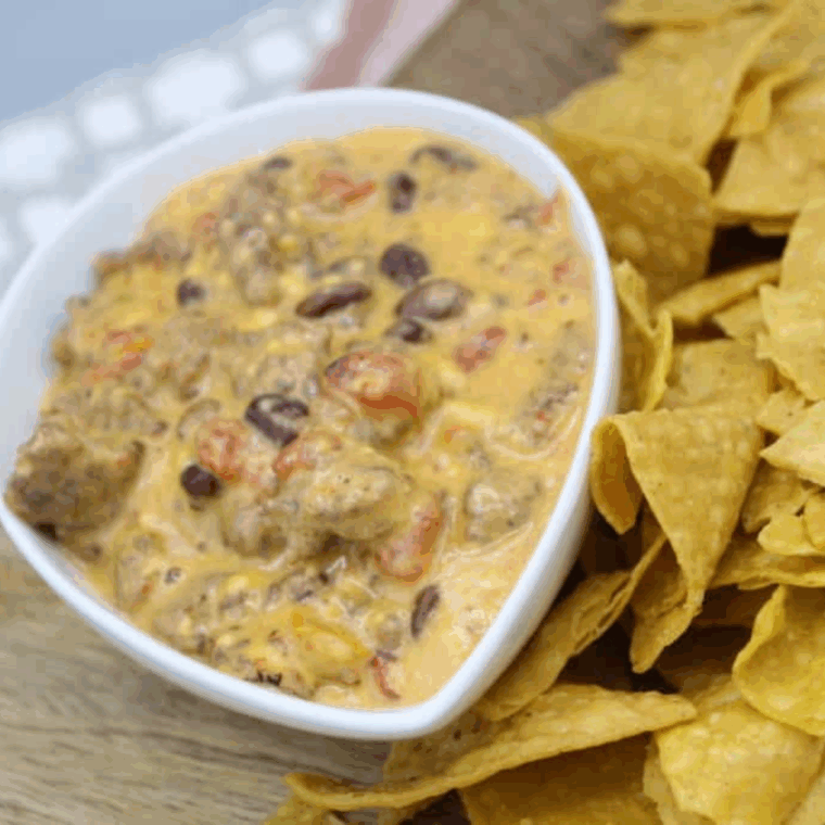Ninja Foodi Spicy Sausage Queso Dip with melted cheese and sausage served with tortilla chips