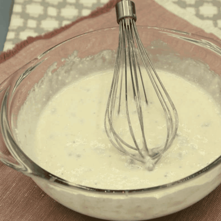 Mixing Martha White muffin mix with milk in a medium bowl until smooth