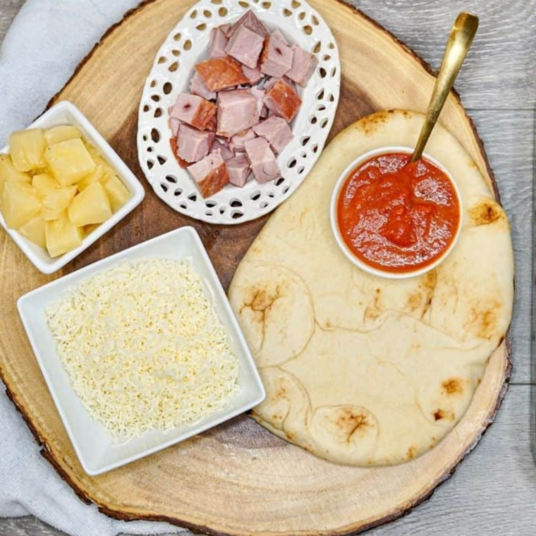 Ingredients needed for Air Fryer Hawaiian Pizza Flat Bread on kitchen table.
