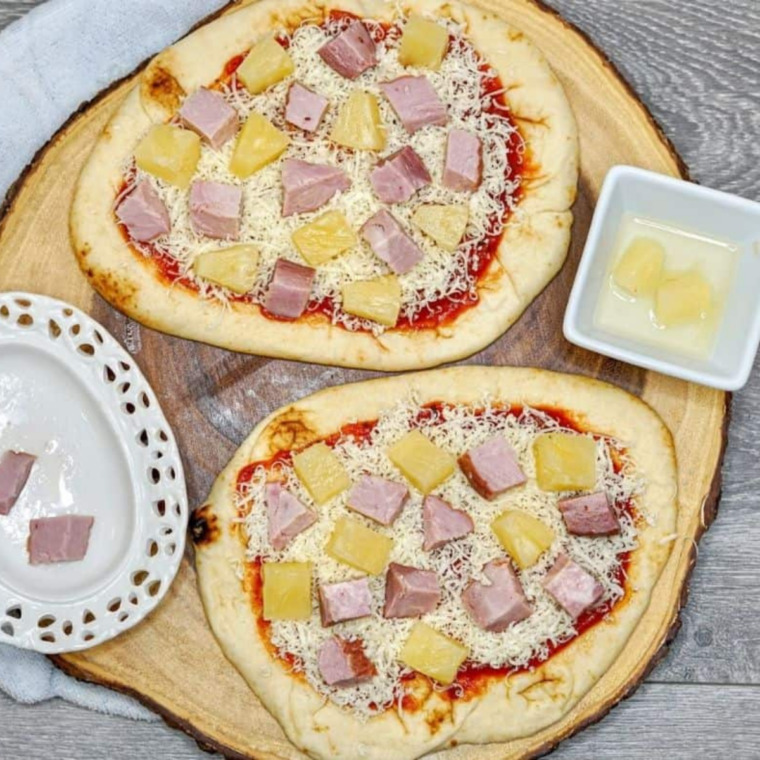 Mozzarella cheese, diced ham, and pineapple layered on naan pizza
