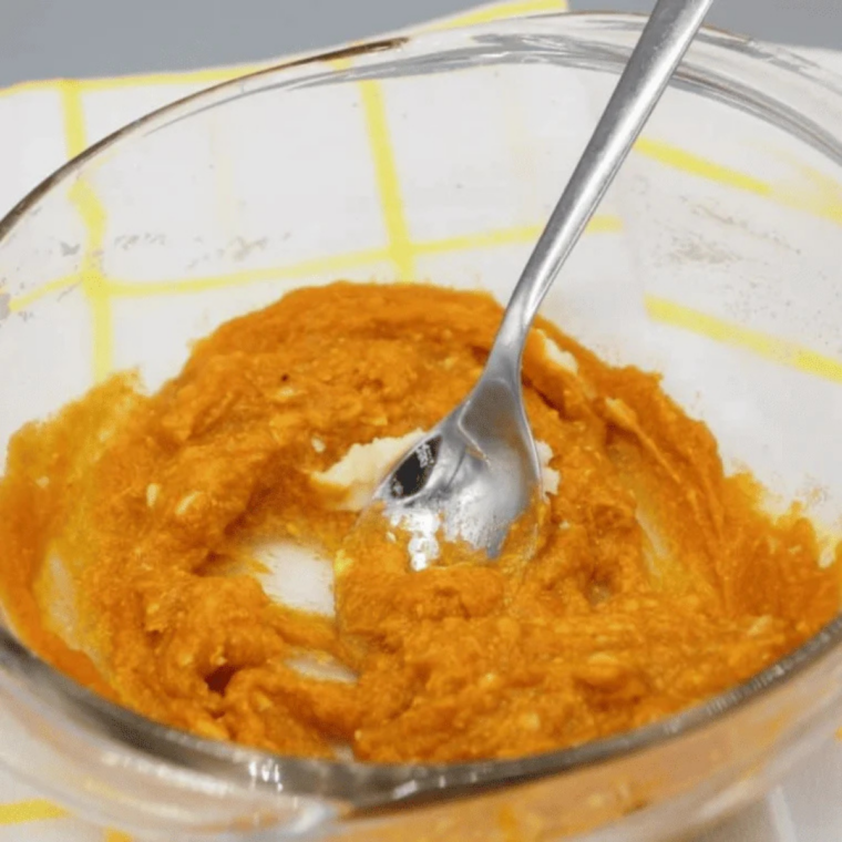 Pumpkin puree and vanilla extract stirred into creamed butter and sugar