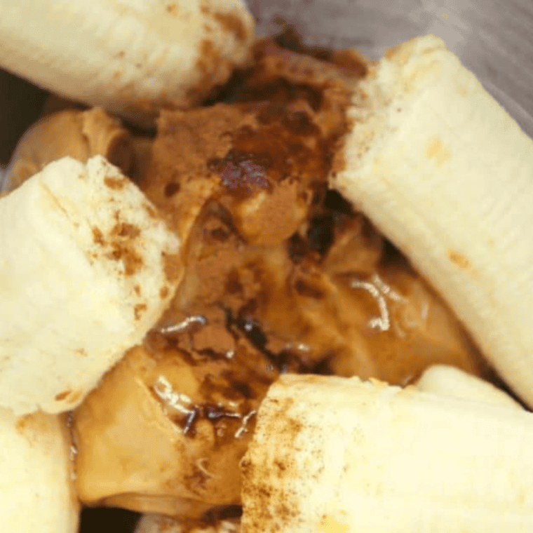 Mixing mashed bananas, quick oats, peanut butter, honey, vanilla, cinnamon, nutmeg, and salt in a large bowl.