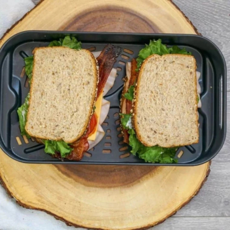 Hot Buc-ee's style Club Melt sandwich partially unwrapped from foil with melted cheese dripping out