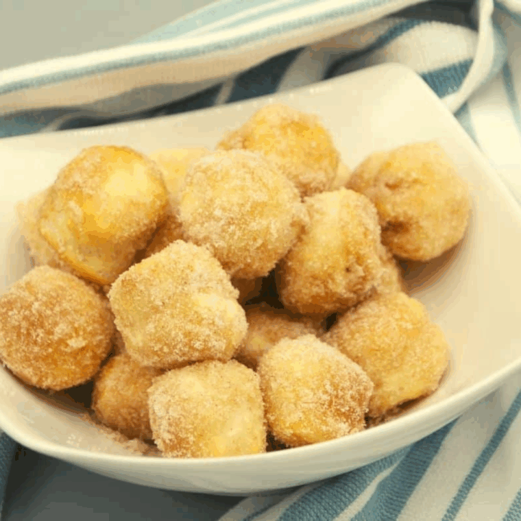 Golden, fluffy Copycat Duck Donuts donut holes arranged on a plate, ready to enjoy.