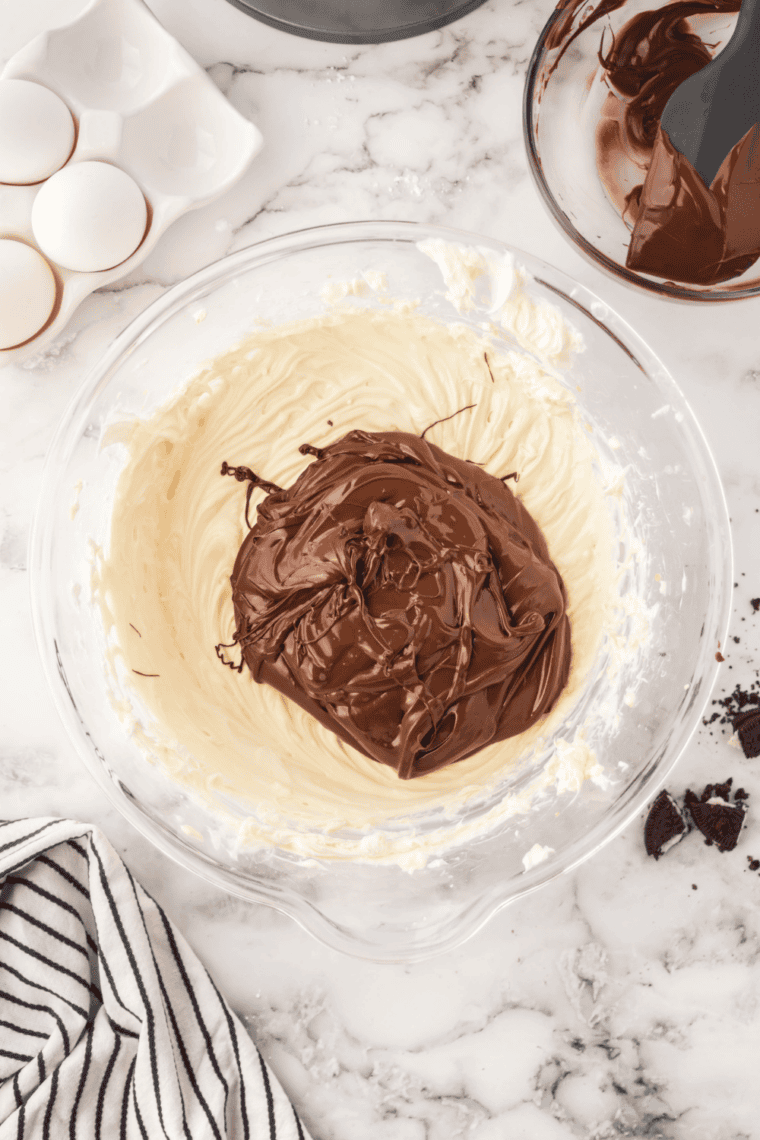Melting chocolate chips in a bowl in the microwave, stirring intermittently.