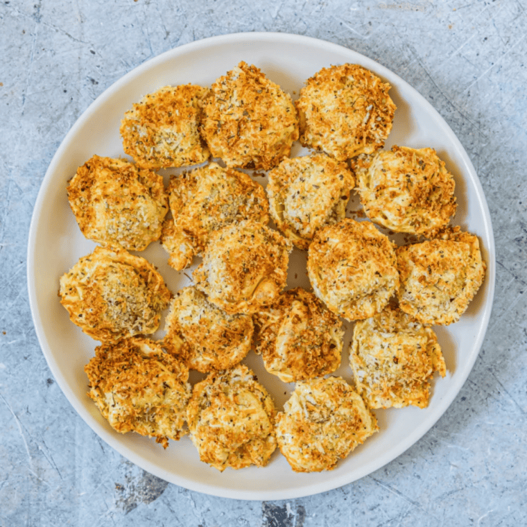 Close-up of crispy tortellini pasta cooked in an air fryer basket