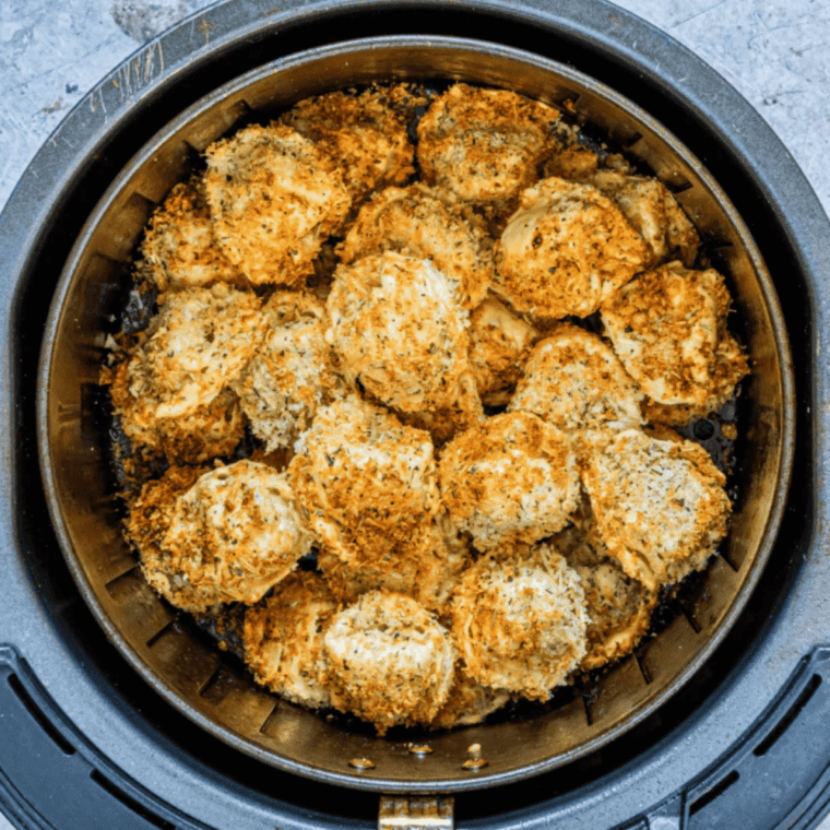 Golden air fryer frozen tortellini in a bowl with marinara dipping sauce