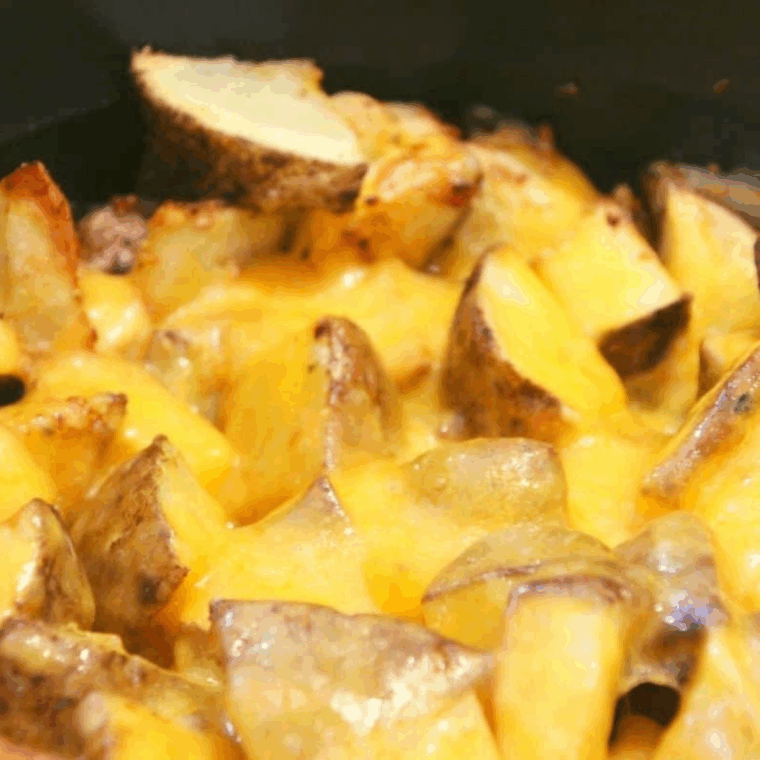 Loaded Ninja Foodi potatoes with melted cheese and crispy bacon