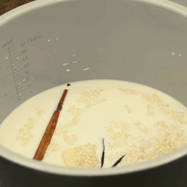 Combine ingredients: Half and half, milk, butter, sugar, Arborio rice, cinnamon stick, and vanilla bean in the Ninja Foodi bowl