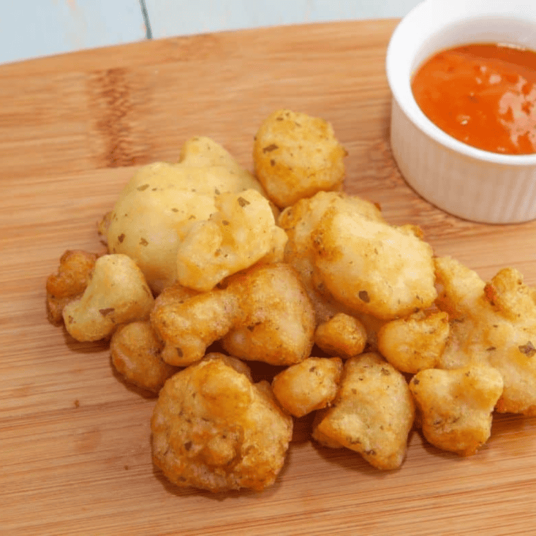 Crispy air fryer cauliflower served with dipping sauce on the side.