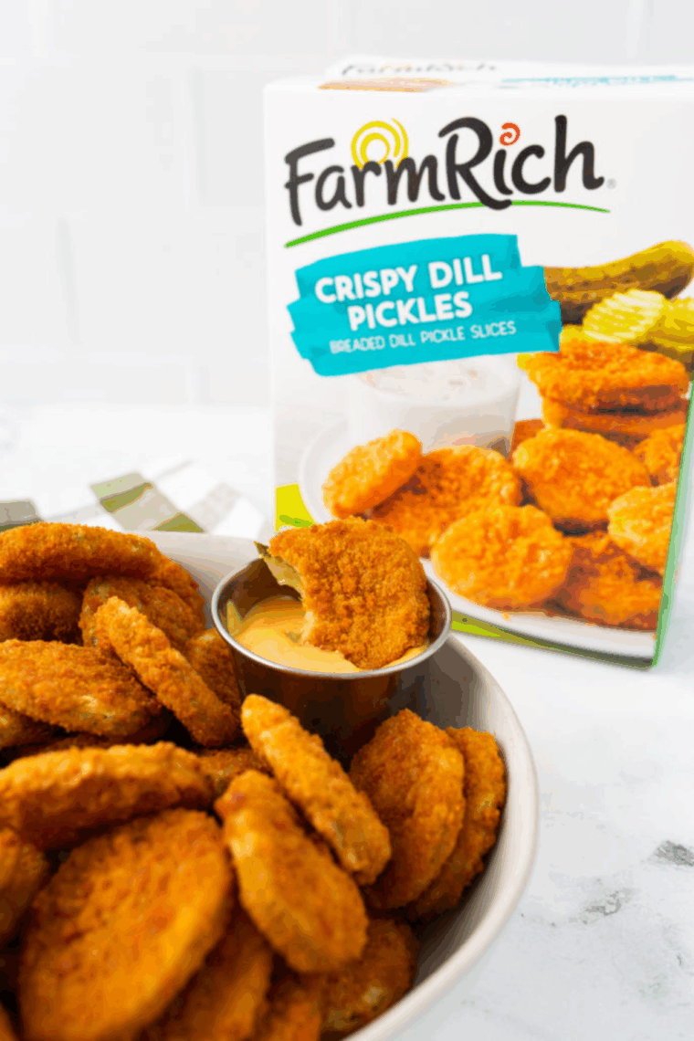 Crispy Air Fryer Farm Rich frozen fried pickles served on a plate with dipping sauce.