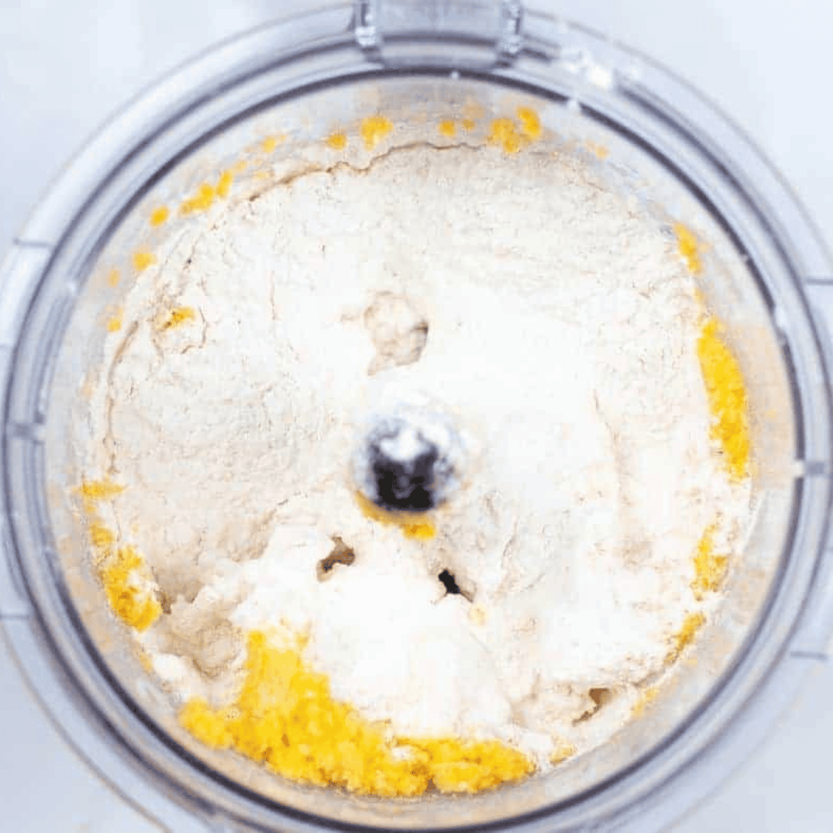Cheese, butter, and seasonings blended in a food processor for cracker dough