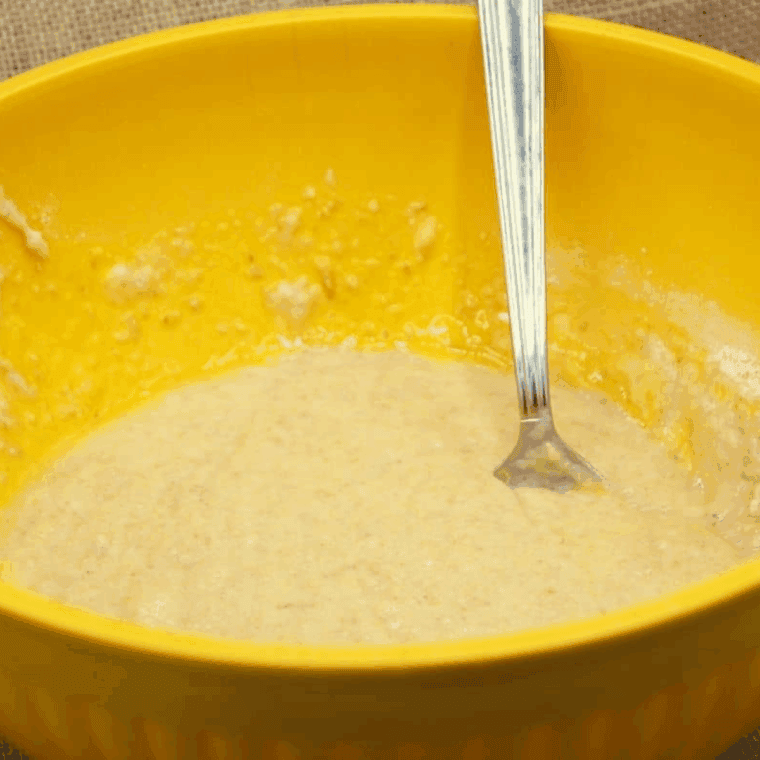 Mixing Trader Joe&rsquo;s banana bread mix with eggs, oil, and water