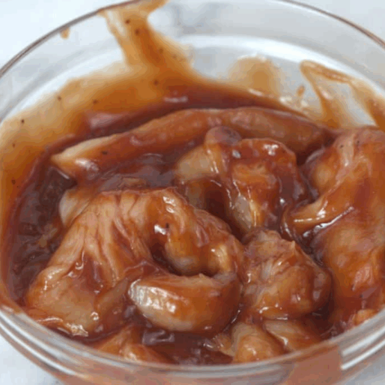BBQ Chicken breast in a bowl marinating.