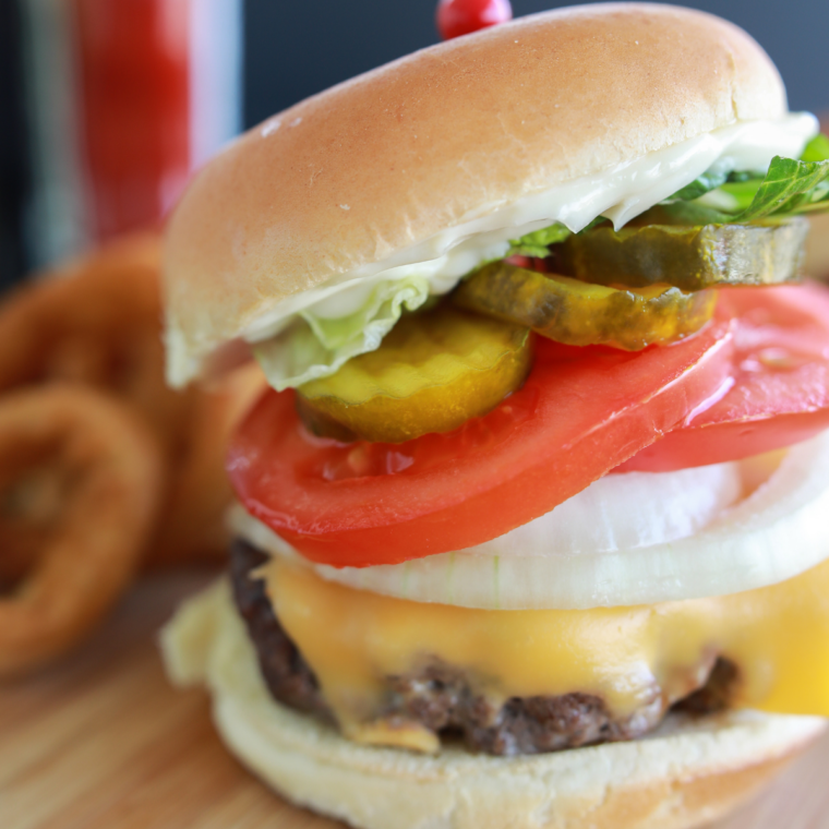 Crispy-edge Blackstone smash burgers topped with melted cheese on toasted buns.