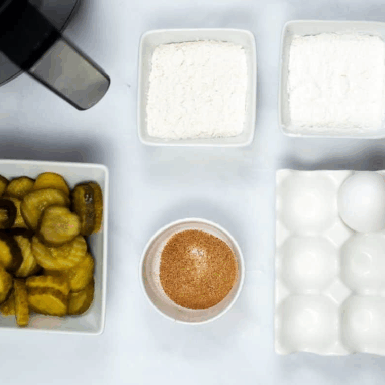 Ingredients needed for Easy Air Fryer Cajun Fried Pickles on kitchen table.