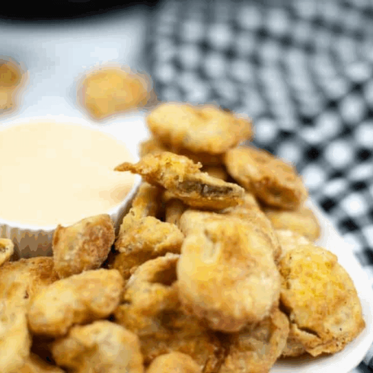 Easy Air Fryer Cajun Fried Pickles served crispy and golden in an air fryer basket
