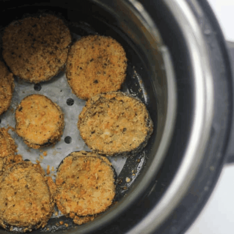 Cooked Gluten-Free Air Fryer Eggplant Parmesan in the air fryer basket.