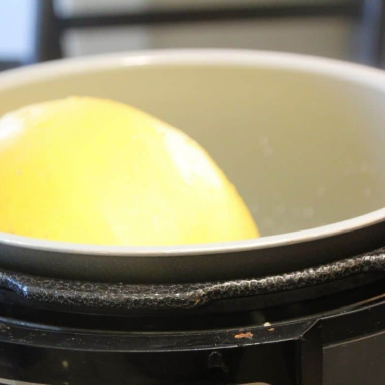 Whole spaghetti squash resting on the trivet inside a Ninja Foodi