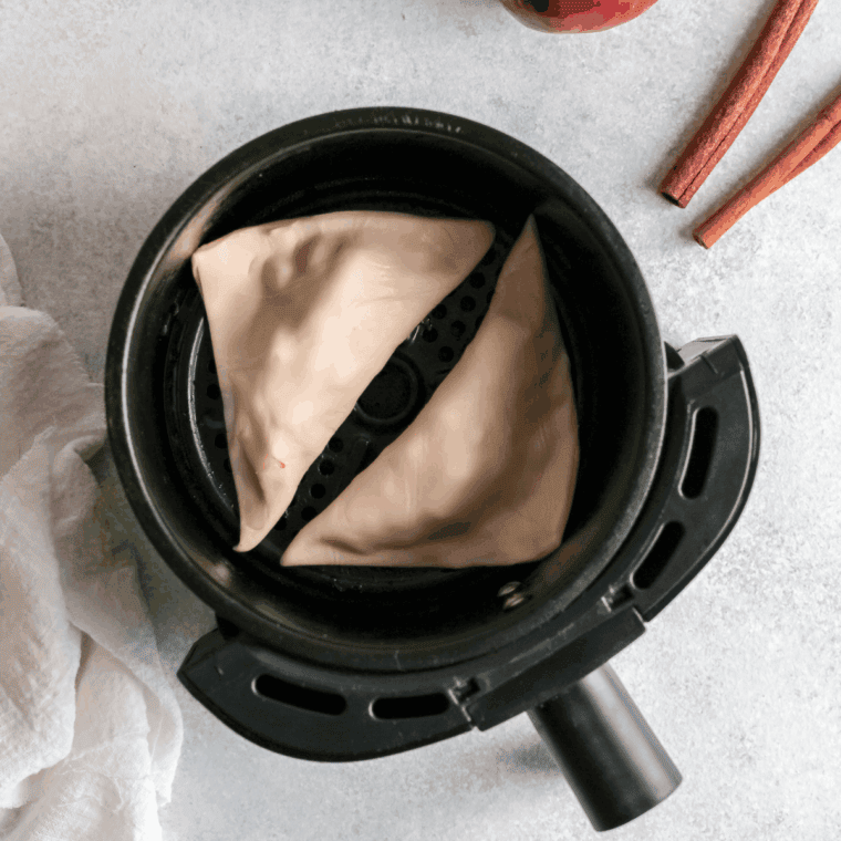 Placing apple turnovers in preheated air fryer at 350°F until golden and puffed