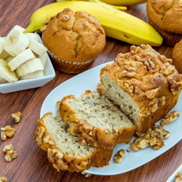 Sliced air fryer banana walnut pound cake with golden crust and walnuts.