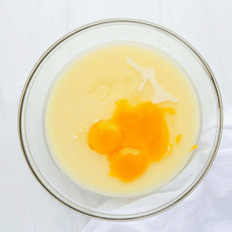 Mixing lemon pie filling with condensed milk, egg yolks, lemon juice, zest, and salt, then pouring into prepared crust and baking in air fryer.