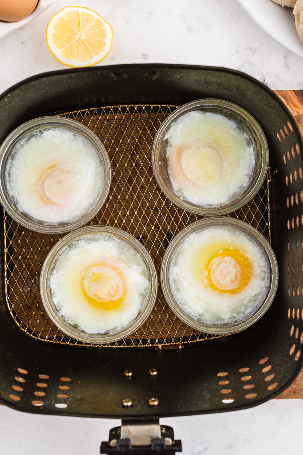 Cooked Poached Eggs in the air fryer basket.