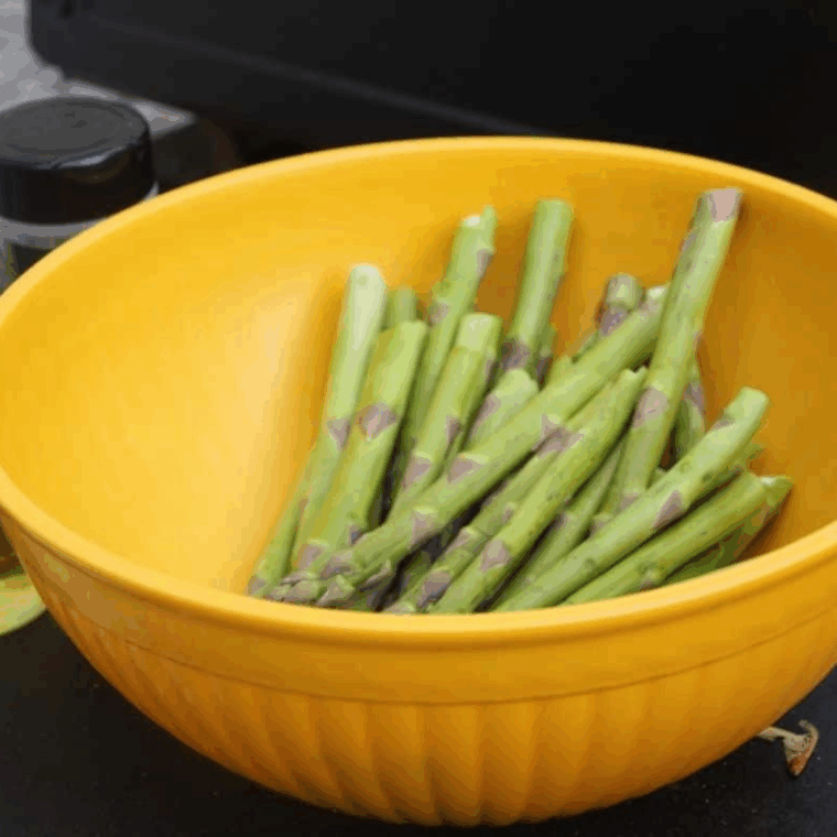 Preparing the Blackstone Griddle for cooking asparagus.