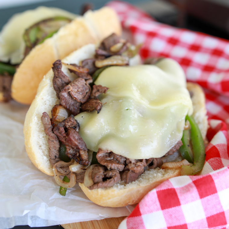 Blackstone Philly Cheesesteak loaded with shaved steak, peppers, onions, and melted cheese on a toasted hoagie roll.