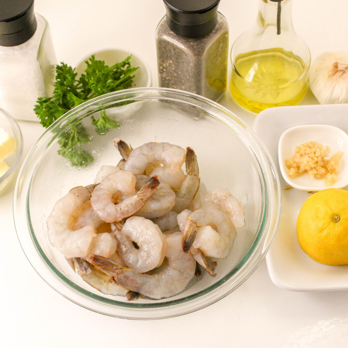 Raw shrimp being thawed, rinsed, and patted dry with paper towels for Blackstone cooking