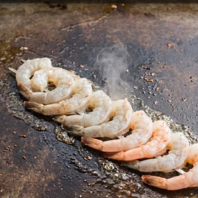 Blackstone griddle heating to medium-high heat for searing shrimp evenly