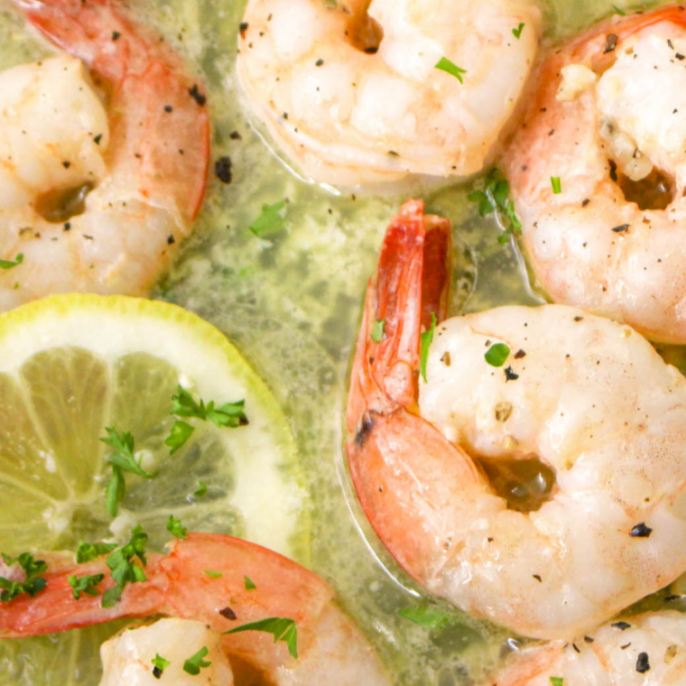 Blackstone garlic butter shrimp served hot on a plate ready to eat with sides or salad