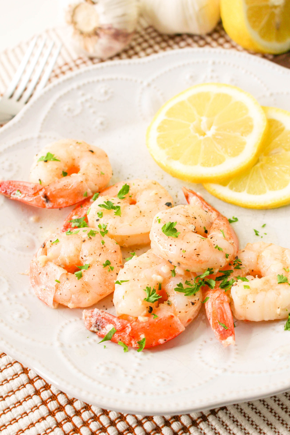 Garlic butter shrimp sizzling on a Blackstone griddle with fresh parsley and lemon