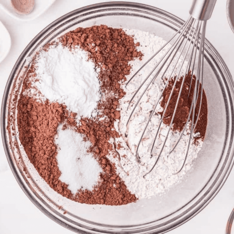 Dry ingredients including flour, cocoa powder, and sugar mixed in a bowl.