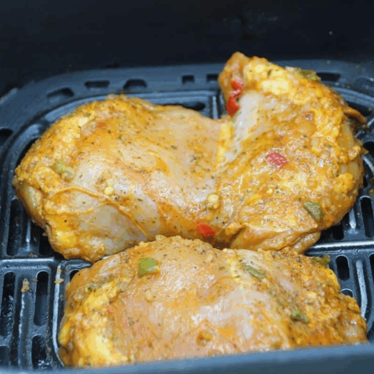 Spray the cooking basket with cooking spray, then add your marinated chicken. Set the air fryer temperature to 350 degrees F, air fryer setting, and set cook time for 20-25 minutes and flipping halfway.