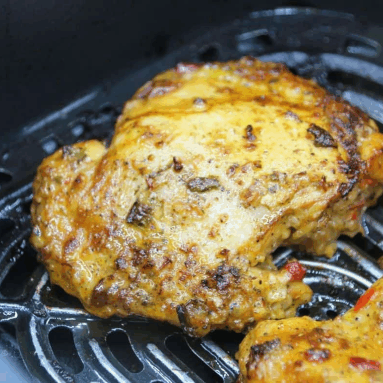 Easy Air Fryer Pollo Asado Chicken in the air fryer basket cooked to 165 degrees F.