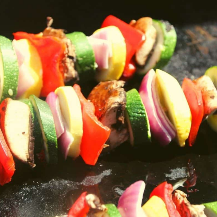 Skewer the Veggies: Colorful vegetable pieces threaded onto skewers, ready to cook.