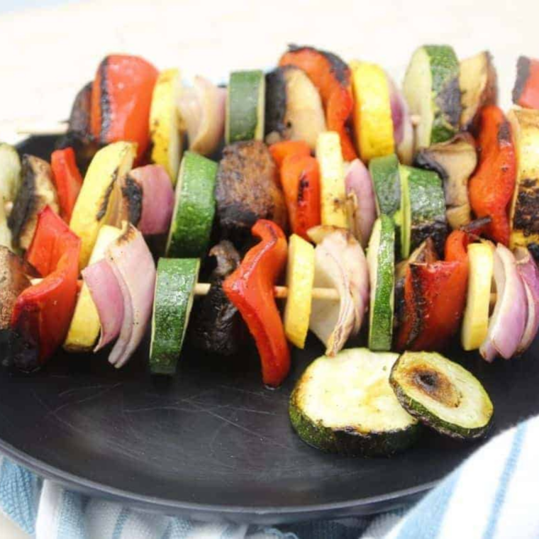 Colorful vegetable skewers cooking on a Blackstone griddle