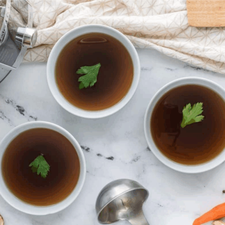 Bowls of Low Sodium Vegetable Stock on kitchen table.