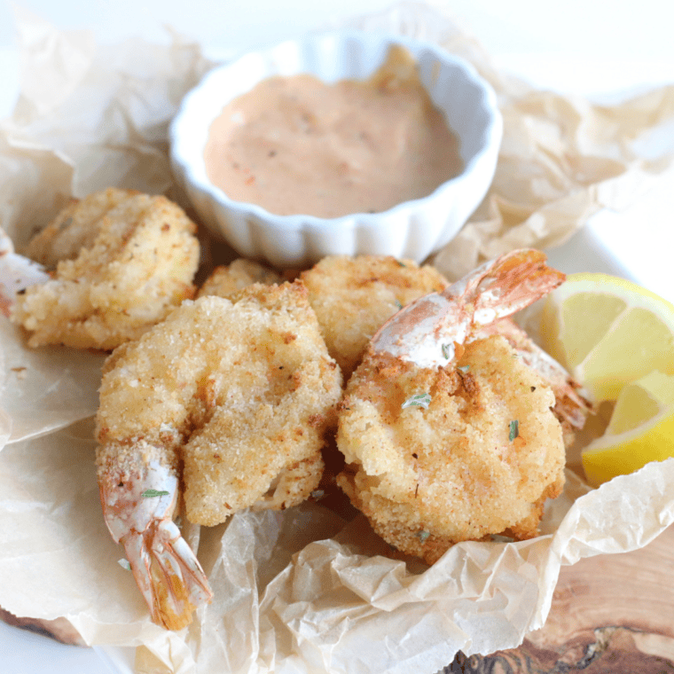 Morton&rsquo;s Steakhouse Shrimp Alexander with creamy Parmesan sauce and parsley garnish on a plate.