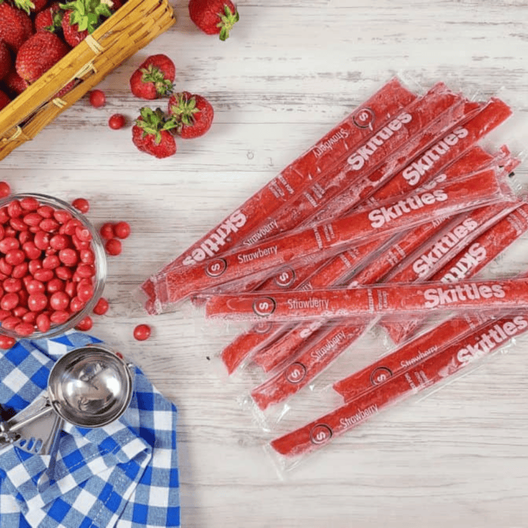 Ingredients needed for Skittles Strawberry Milkshake on kitchen table.