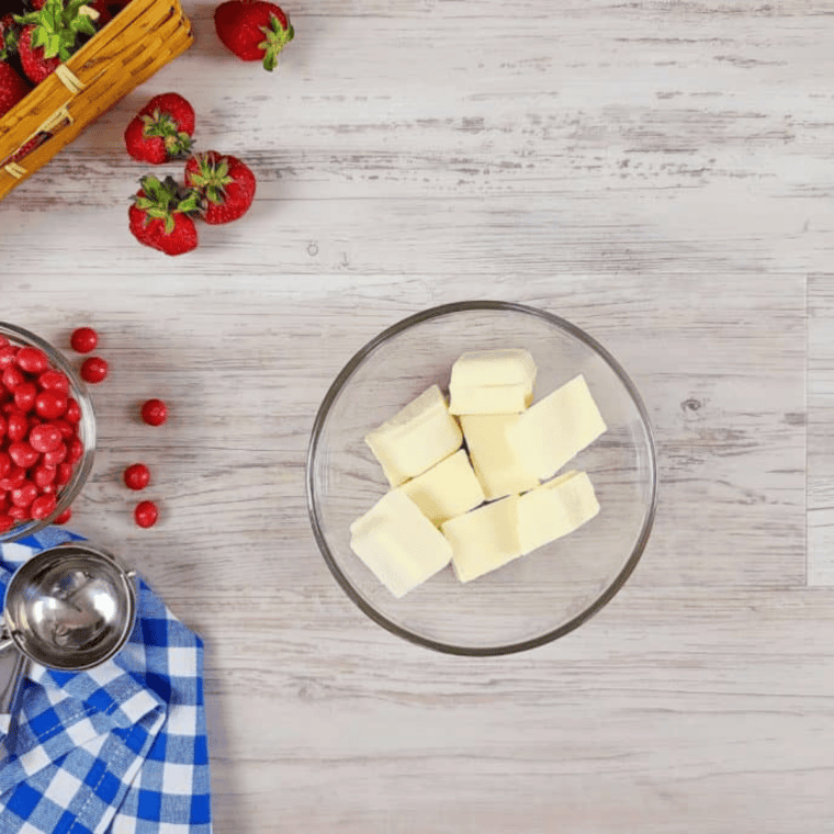 Melting white chocolate almond bark in a bowl, stirring until smooth and slightly thick.