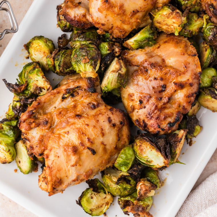Crispy bacon and deep brown, lightly charred Brussels sprouts in the air fryer basket, fully cooked