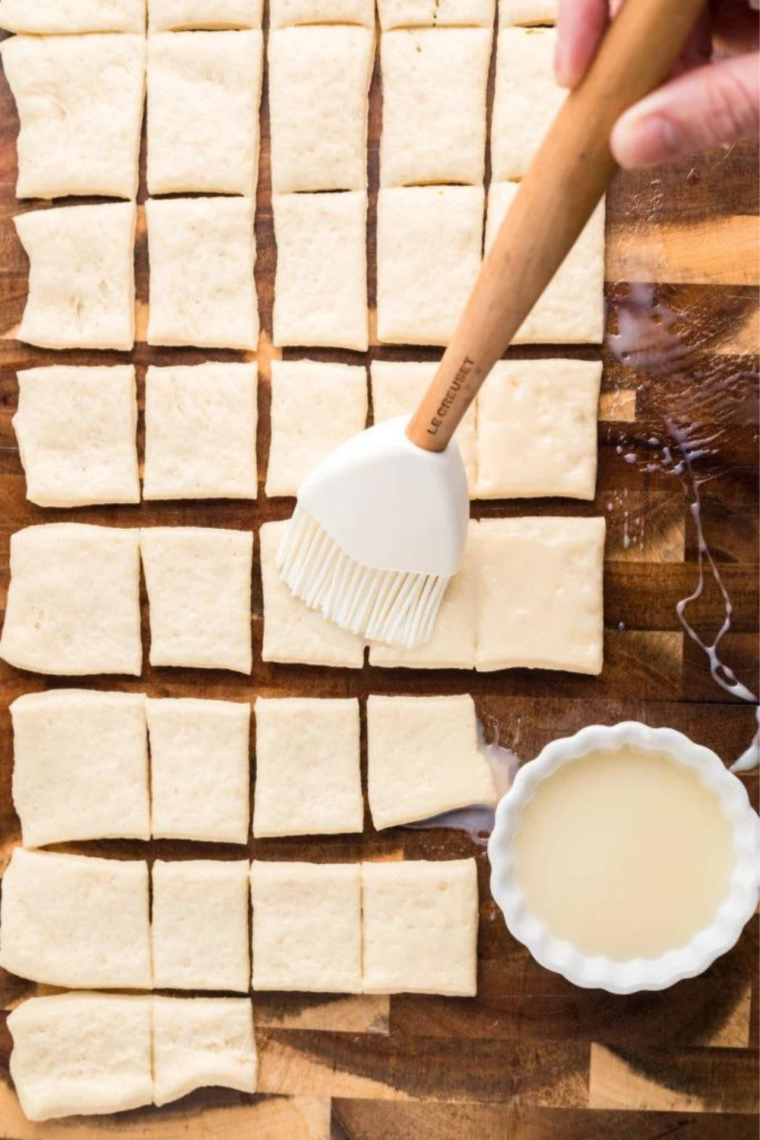 Thawed puff pastry sheet cut into 12 even squares using knife or pizza cutter on flat surface