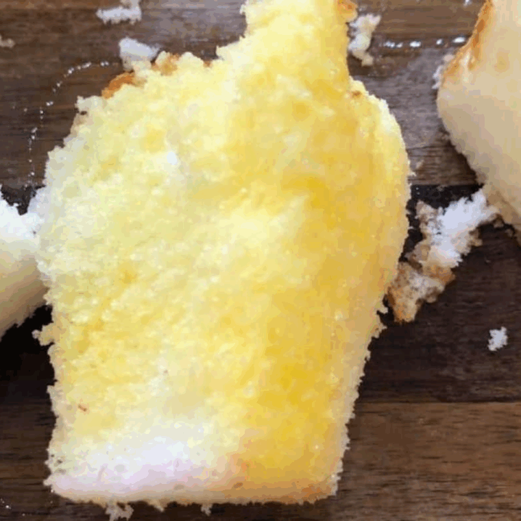 Butter the angel cake lightly.