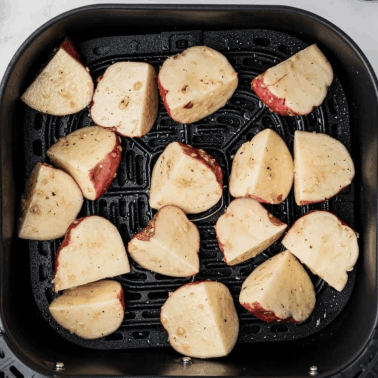 Lightly spray the air fryer basket with oil, cook potatoes for 15&ndash;20 minutes, and serve hot.